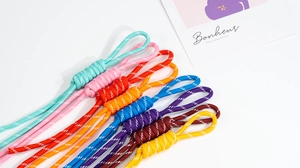 Macro detail of multi-color hand-woven lanyards for backpacks and keychains