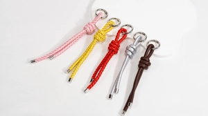 Detail of colorful hand-woven leather lanyards with silver round spring metal clasps