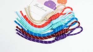 Close-up of colorful braided paracord lanyards with adjustable loops for DIY accessories