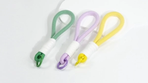 Macro detail of thick woven macaron lanyards with metal spring buckles in three colors