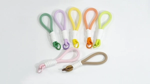 Detail of colorful braided rope wristlets with metal rings in various macaron colors