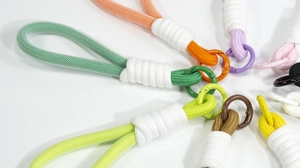 Macro view of colorful hand-woven lanyards with round metal spring ring clasps