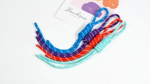 Close-up of four colorful handmade braided nylon lanyards for bags and keychains