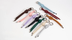 Detailed close-up of handmade leather knot keychains in ten vibrant assorted colors