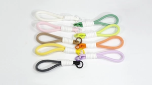 Detailed grid of colorful hand-woven backpack keychains with spring metal rings