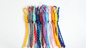 Detailed view of colorful woven lanyards with reflective threads and pre-made loop ends