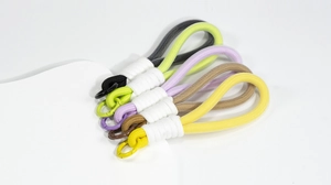 Detail of colorful hand-woven braided lanyards with spring buckles in five vibrant colors