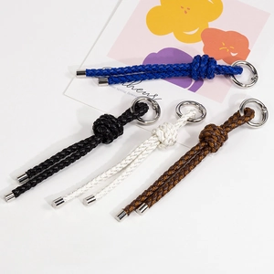 Handmade woven PU leather keychain charms with polished metal rings in four colors