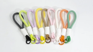 Detailed view of ten colorful hand-woven lanyards with matching metal spring rings