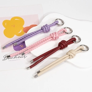 Handmade woven leather keychain strap set in purple pink and burgundy with silver ring