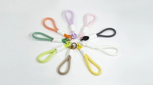 Detailed macro view of colorful macaron braided ropes with silver metal lobster clasps