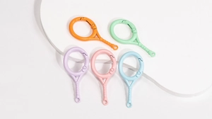 Close-up of five colorful tennis racket shaped spring buckles for DIY keychains