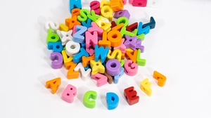 Dettaglio di perline colorate in acrilico con lettere per creazione di gioielli DIY