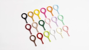 Top view of colorful tennis racket shape lobster clasps in eighteen various vibrant finishes