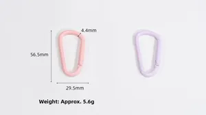 Macro detail of D-shape aluminum carabiner with precise dimensions in pink and purple finish