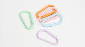 Macro detail of D-shaped spring carabiners in macaron paint finishes for DIY keychains