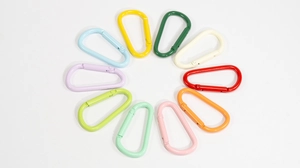 Circle arrangement of ten colorful D-ring spring carabiners in various painted finishes