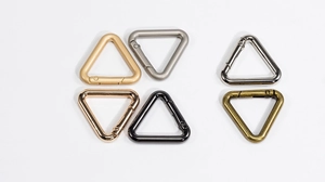 Detail view of triangular spring clips in six polished metal finishes for keychains