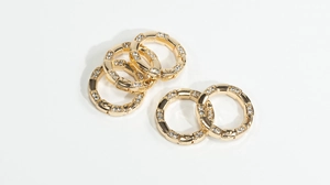 Macro shot of five gold-plated spring rings with cubic zirconia for DIY accessories