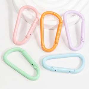Matte finish colorful D-shaped spring carabiners in five pastel colors on a white pedestal