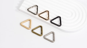 Detailed display of triangle spring snap hooks in various metallic finishes and colors