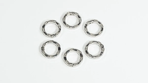 Detailed view of silver spring gate rings with diamond accents for DIY jewelry accessories