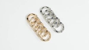 Detailed view of gold and silver rhinestone spring rings for DIY jewelry making