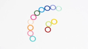 Detailed flat lay of 10mm colorful lacquered metal open jump rings for DIY jewelry making