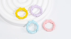Close-up of pastel macaron bow spring rings for DIY keychain and jewelry making