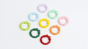 Macro shot of colorful bow-shaped alloy spring rings for DIY jewelry accessories