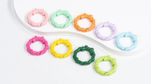 Close-up of colorful octagon spring snap rings with decorative bows in pastel shades