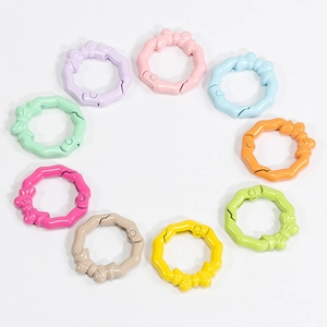 Set of 9 colorful bow-shaped spring rings in pastel macaron colors for DIY keychains
