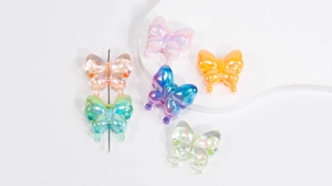 Macro detail of transparent butterfly acrylic beads with AB iridescent finish and center hole
