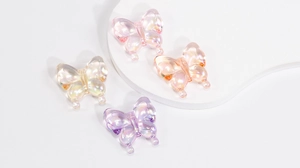 Macro detail of iridescent butterfly acrylic beads for DIY jewelry with small stringing holes
