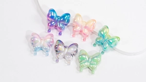 Macro shot of colorful iridescent acrylic butterfly beads for DIY jewelry and crafts