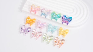 Macro shot of colorful iridescent acrylic butterfly beads with holes for DIY jewelry