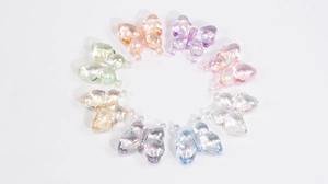 Macro view of transparent colorful acrylic butterfly beads with aurora finish for DIY crafts
