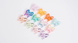 Detail view of colorful acrylic butterfly beads with iridescent AB coating for DIY crafts