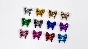 Macro view of 12 colorful butterfly acrylic beads with metallic electroplated mirror finish