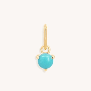 Macro detail van vergulde ronde hanger met turquoise steen en klauwzetting