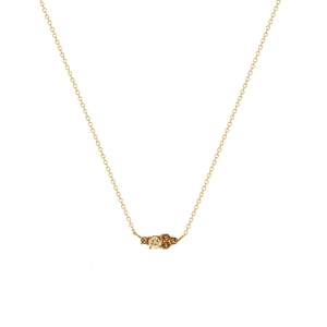Detail of gold chain necklace featuring yellow and coffee gemstones in a vintage cluster