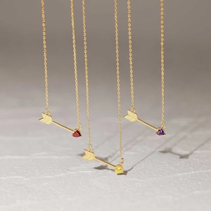 Detailed close-up of 18K gold-plated necklaces with colorful heart-shaped crystal pendants