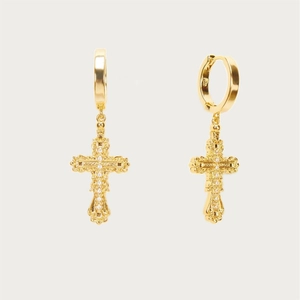 Detailopname van gouden gothic kruis oorringen met ingelegde glinsterende kristallen