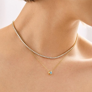 Layered gold necklace with tennis chain and round blue gemstone pendant for women