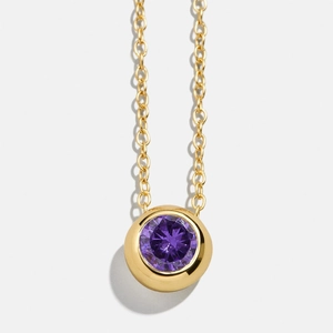 Minimalist gold necklace featuring a round purple birthstone pendant on a classic cable chain