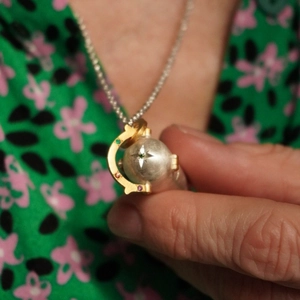 Spherical locket necklace with star engraving and multi-color zircon stones