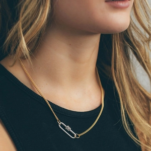 Detail of two-tone carabiner clasp necklace with star engraving on black top model