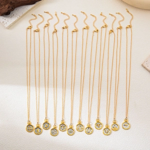 Set of 12 zodiac sign necklaces with two-tone 18K gold plated circular seal pendants