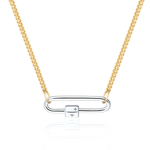 Detailed macro view of two-tone cuban chain necklace featuring an engraved star carabiner lock