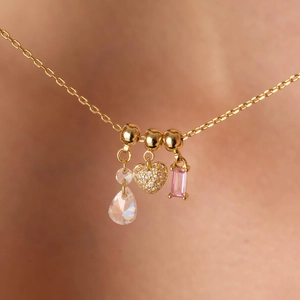 Gouden hoefijzer hart ketting met kristallen druppel en roze edelsteen hanger